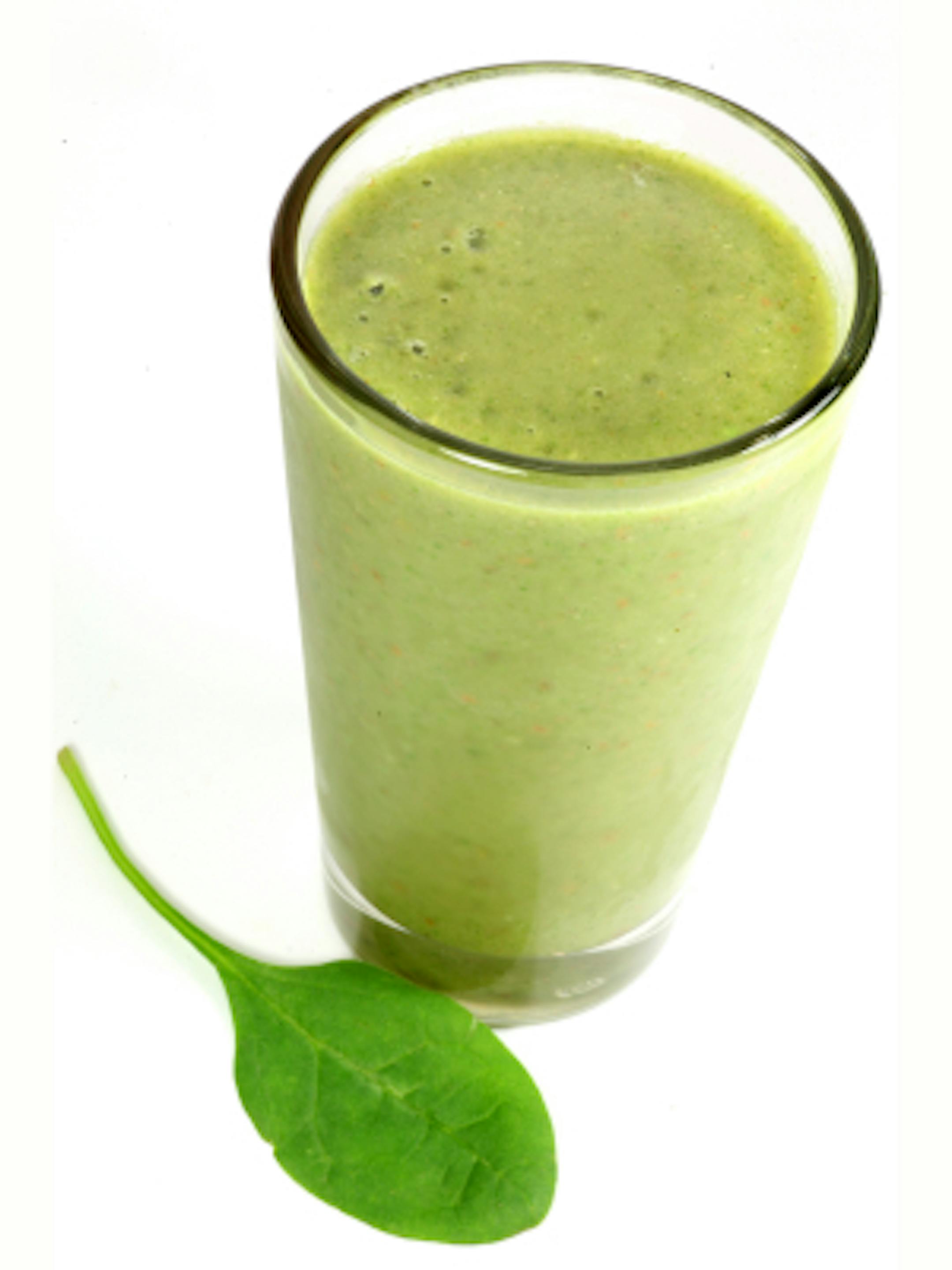 A healthy drink containing fruit and vegetable juices as well as spinach.