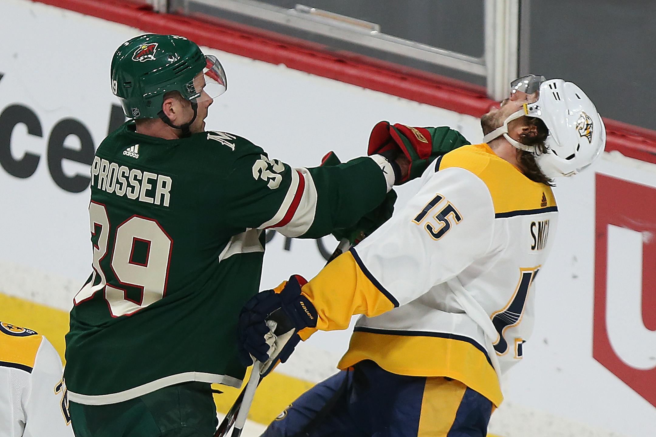 Minnesota Wild's Nate Prosser (39) shoves Nashville Predators' Craig Smith (15) in the first period of an NHL hockey game Saturday, March 24, 2018, in St. Paul, Minn. (AP Photo/Stacy Bengs)