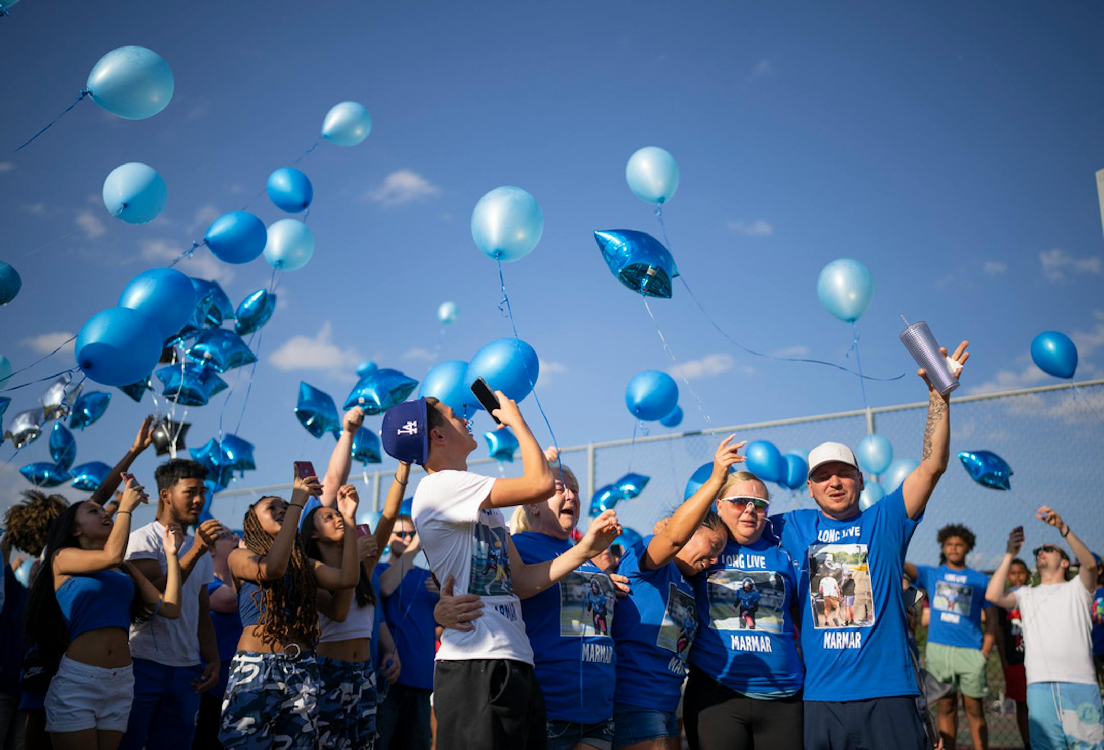 Demaris Hobbs-Ekdahl's mother, Trisha Eckdahl, center released balloons along with her sister, Katie Eckdahl, and brother Jeff Eckdahl, right. With them was her son's best friend, Michael Pflepsen, left, and his grandmother, Penny Eckdahl. ] JEFF WHEELER • jeff.wheeler@startribune.com