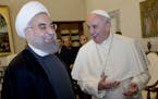 Pope Francis and Iranian President Hassan Rouhani, left, share a laugh during their private audience at the Vatican,Tuesday, Jan. 26, 2016. Iran�s p