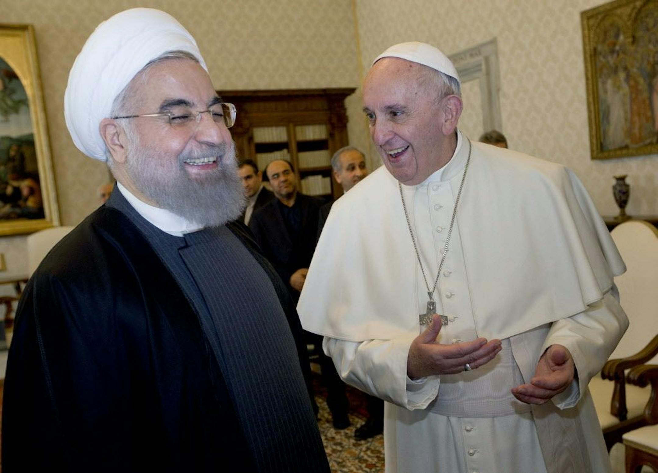 Pope Francis and Iranian President Hassan Rouhani, left, share a laugh during their private audience at the Vatican,Tuesday, Jan. 26, 2016. Iran�s president has paid a call on Pope Francis at the Vatican during a European visit aimed at positioning Tehran as a potential top player in efforts to resolve Middle East conflicts, including Syria�s civil war.