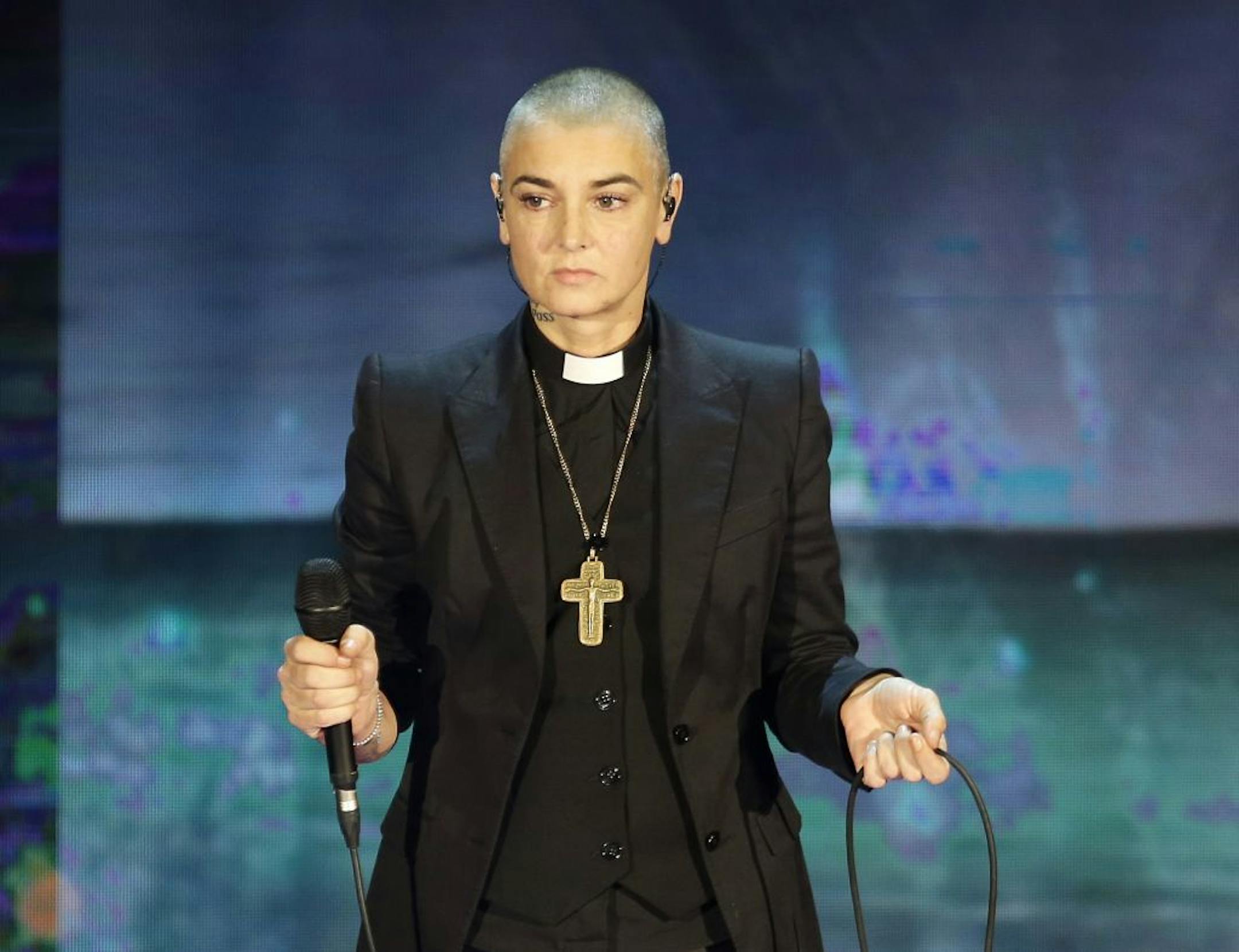 FILE - In this Oct. 5, 2014 file photo, Irish singer Sinead O'Connor performs during the Italian State RAI TV program "Che Tempo che Fa", in Milan, Italy. Arsenio Hall sued O'Connor for libel on Thursday, May 5, 2016, in Los Angeles Superior Court over a Facebook post by the singer in which she accused the comedian of furnishing drugs to Prince, who died on April 21, 2016. Investigators are looking into whether he overdosed.