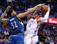 Minnesota Timberwolves center Karl-Anthony Towns (32) defends Oklahoma City Thunder center Enes Kanter (11) in the fourth quarter of an NBA basketball