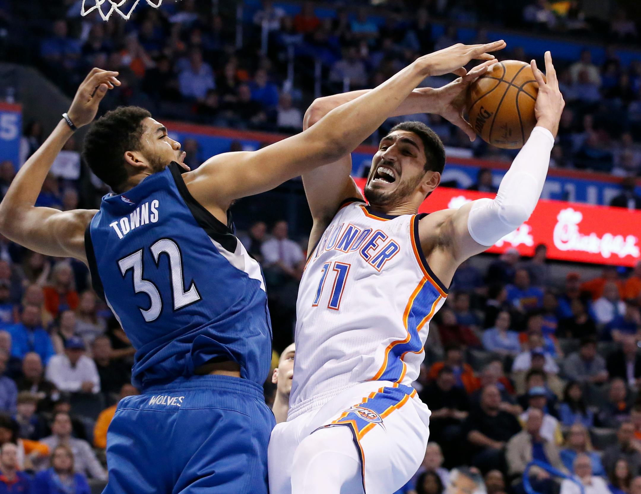 Minnesota Timberwolves center Karl-Anthony Towns (32) defends Oklahoma City Thunder center Enes Kanter (11) in the fourth quarter of an NBA basketball game in Oklahoma City, Friday, March 11, 2016. Minnesota won 99-96. (AP Photo/Sue Ogrocki)