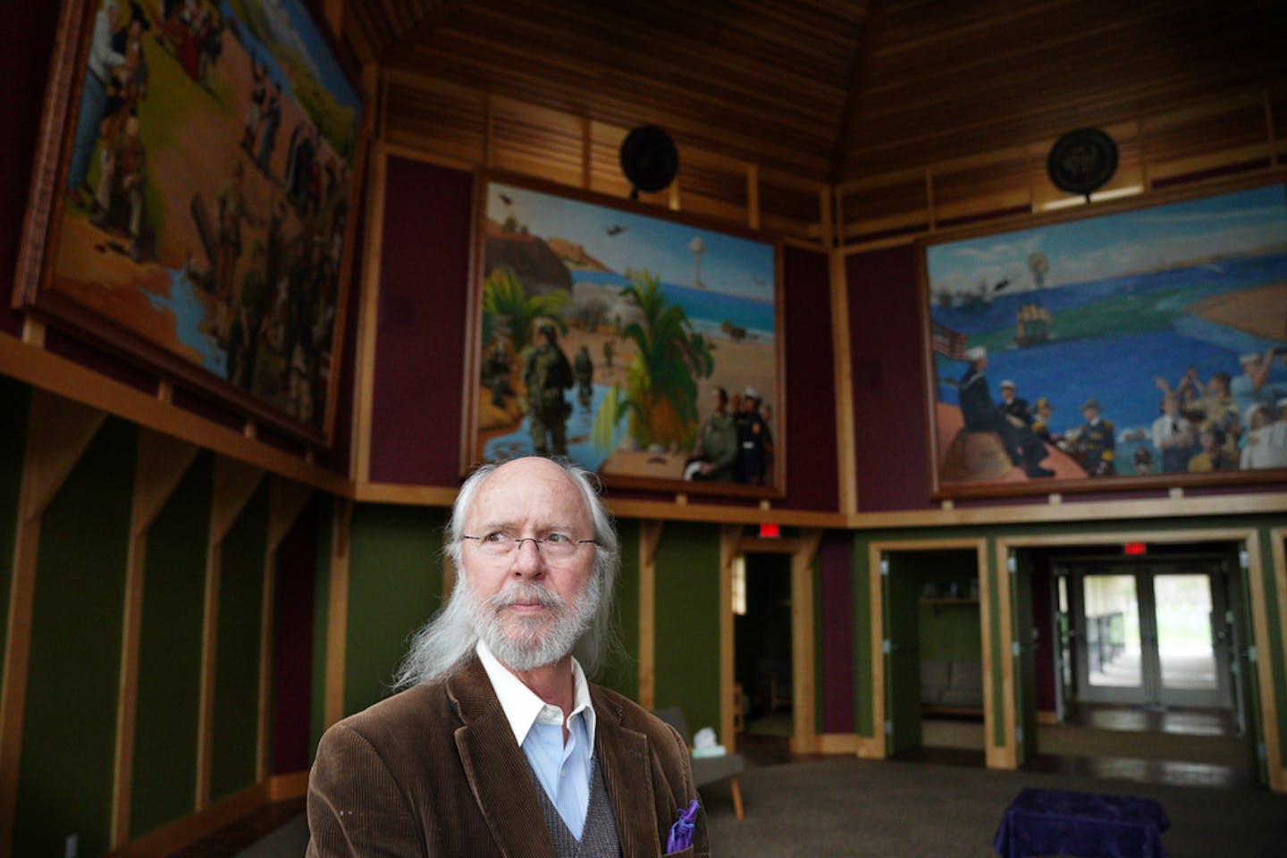 Artist Charles Gilbert Kapsner stood for a portrait with three of the five murals for his 10-year U.S. war veterans project at the Minnesota State Veterans Cemetery. ] ANTHONY SOUFFLE • anthony.souffle@startribune.com Classically trained Italian fresco painter Charles Gilbert Kapsner worked on the last of five murals for his 10-year U.S. war veterans project Wednesday, May 8, 2019 at his studio in Little Falls, Minn. The murals, which are on view at the MN State Veterans Cemetery, are meaningful