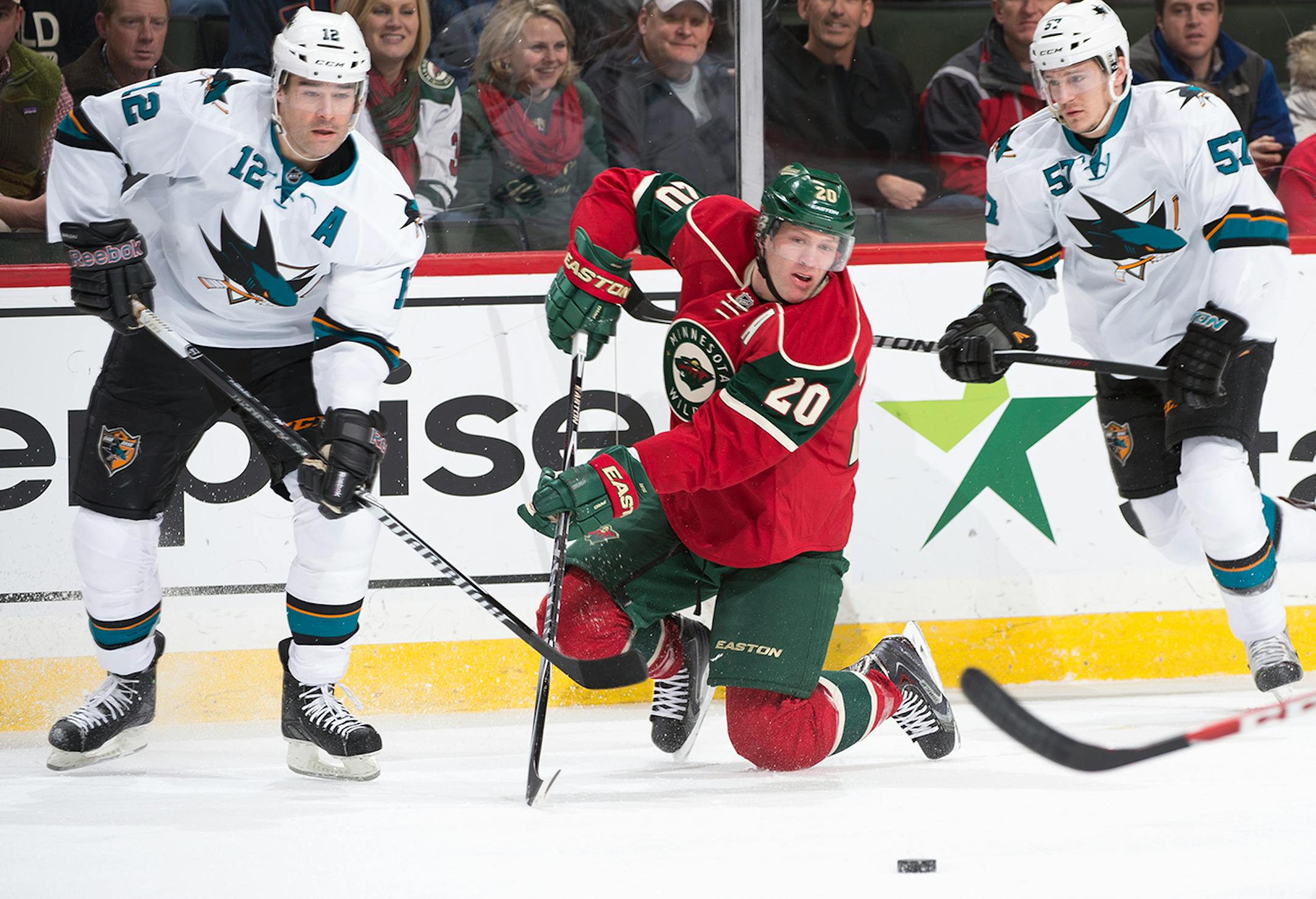 Minnesota Wild defenseman Ryan Suter (20) goes down to the ice for the puck while being challenged by San Jose Sharks center Patrick Marleau (12) and center Tommy Wingels (57) during the first period. ] (Aaron Lavinsky | StarTribune) The Minnesota Wild take on the San Jose Sharks Tuesday, Jan. 6, 2014 at Xcel Energy Center in St. Paul.