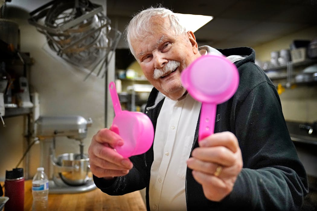 Classic Cookie Co. owner John Lundgren, 88, showed off his trusty measuring cups; the size of the cups wore off the handle so Lindgren drilled holes to denote the size.