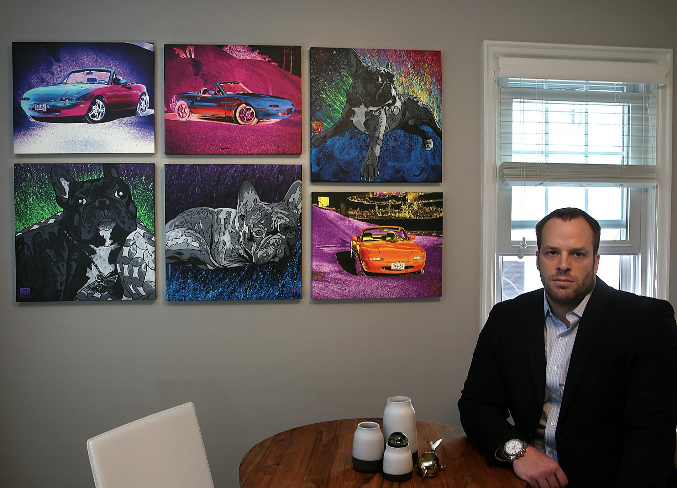 Tim Jarvis at home with canvasses by local artists.