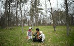 Jovan C. Speller watches and tends to her children Silas, 4, and Felix, 2, as she works on a sketch of her husband Thursday, May 19, 2022 in Osage, Mi