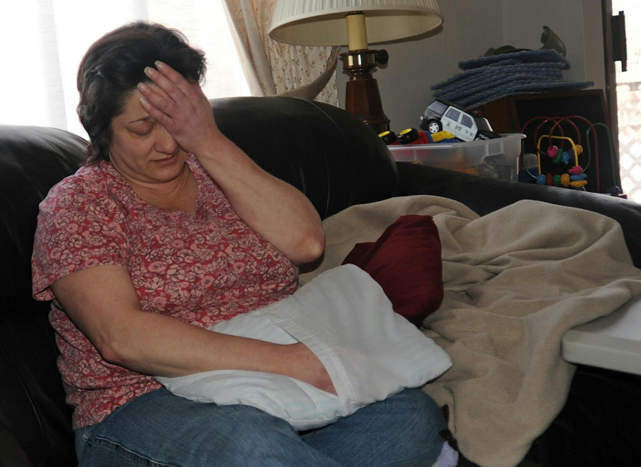 Day-care provider Janelle Rutzen was in tears Thursday as she talked about finding an 8-month-old boy unresponsive in his crib on Wednesday. The boy died despite efforts of Rutzen, her daughter, Kari Rutzen, and 911 responders.