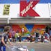 Community members, organized by local artist and muralist Melodee Strong and Kmart, came out to paint the outside of the Kmart on Nicollet Saturday mo