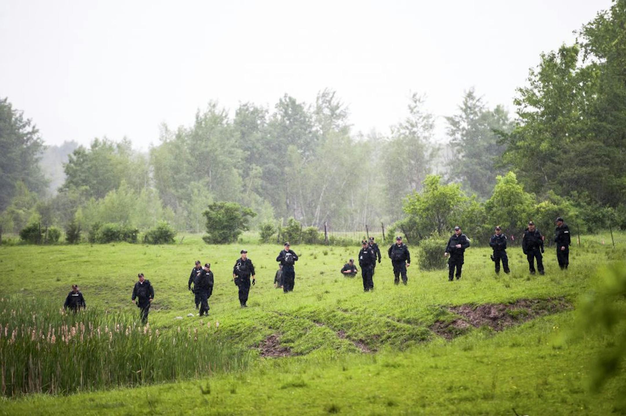 New York Department of Corrections officers search an area near Essex, N.Y., after a tip led them to believe two inmates who escaped from the Clinton Correctional Facility may be nearby, June 9, 2015. The two convicted murders escaped the prison on Saturday by tunneling their way out, setting off an extensive manhunt.