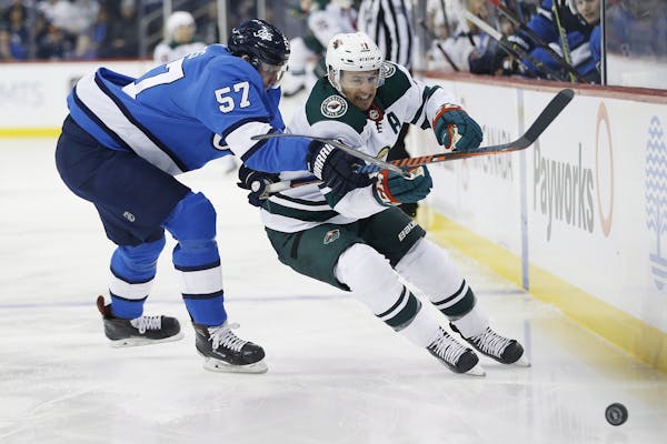 Winnipeg Jets' Tyler Myers (57) can't stop Minnesota Wild's Zach Parise (11) as he blasts past during first period NHL action in Winnipeg, Manitoba, o