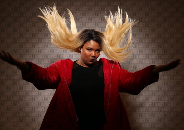 The singer Lizzo was photographed at the Minneapolis College of Art and Design before a show. The wallpaper backdrop is a student piece in the gallery