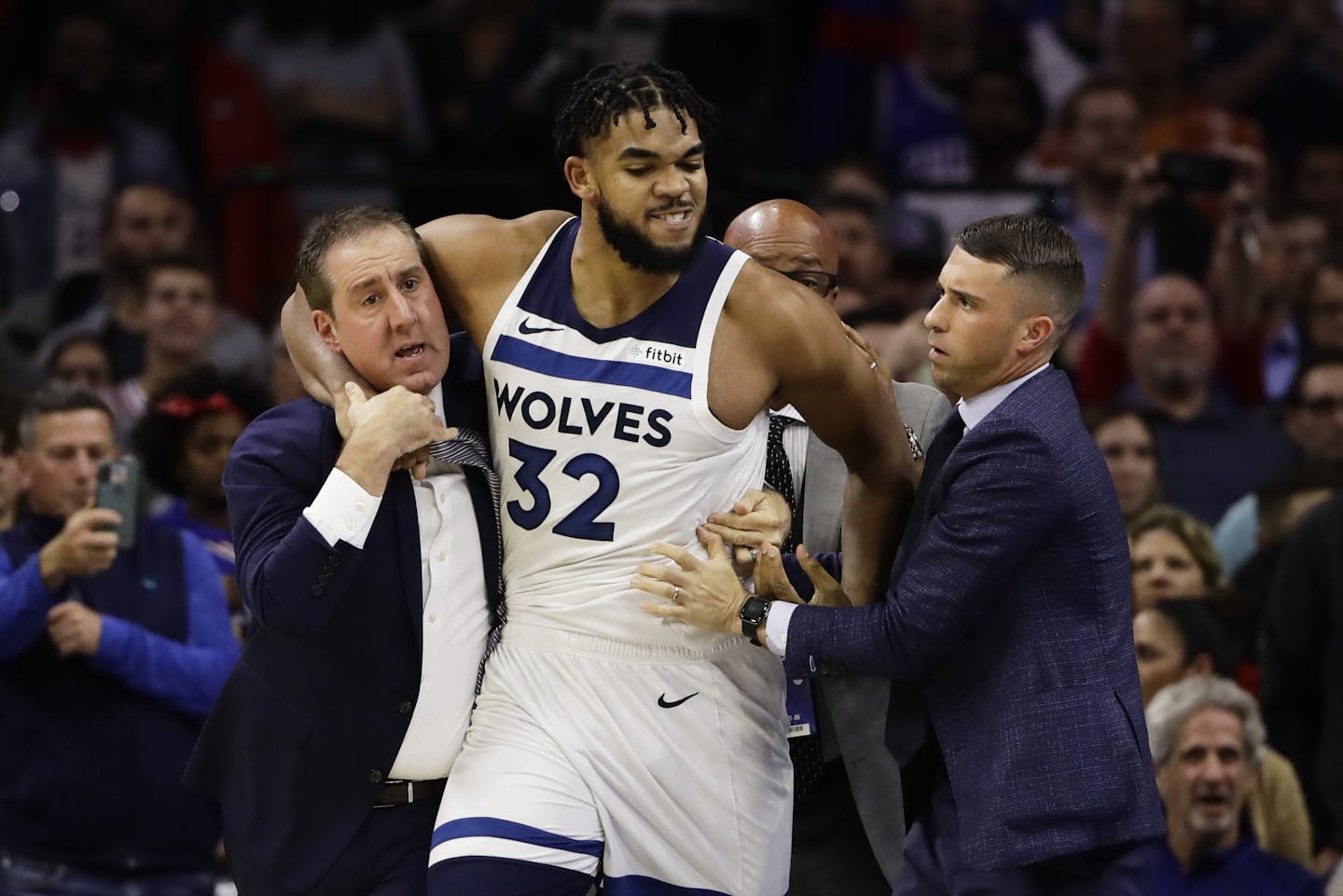 Minnesota Timberwolves' Karl-Anthony Towns is led away after an altercation with Philadelphia 76ers' Joel Embiid during the second half of an NBA basketball game Wednesday, Oct. 30, 2019, in Philadelphia. Both players were ejected. The 76ers won 117-95.