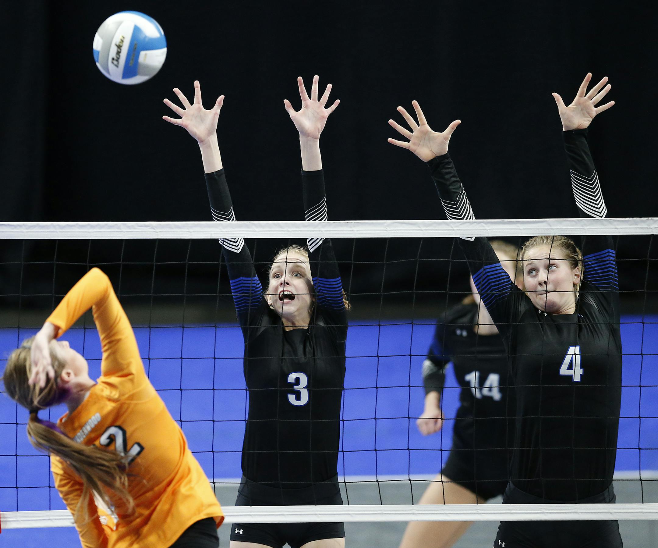 Underwood's Brenna Tinjum (12) hits the ball as Heritage Christian Academy's Jordyn Allen (3) and Heritage Christian Academy's Bella Lien (4) block. ] (Leila Navidi/Star Tribune) leila.navidi@startribune.com BACKGROUND INFORMATION: Heritage Christian High School against Underwood High School in the Class 1A volleyball quarterfinals at the Xcel Energy Center in St. Paul on Thursday, November 10, 2016.