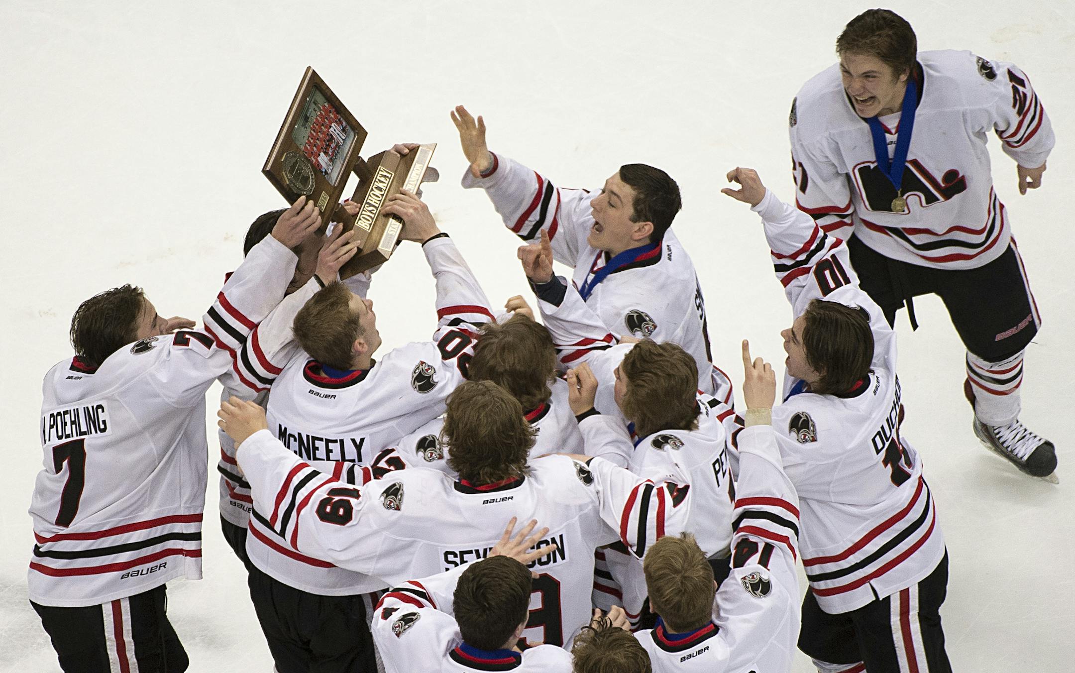 Lakeville North players celebrate hoist their championship trophy over their heads after defeating Duluth East in the Class 2A boys' hockey championship game on Saturday night. ] (Aaron Lavinsky | StarTribune) Duluth East plays Lakeville North in the Class 2A boys' hockey championship game on Saturday, March 7, 2015 at Xcel Energy Center.