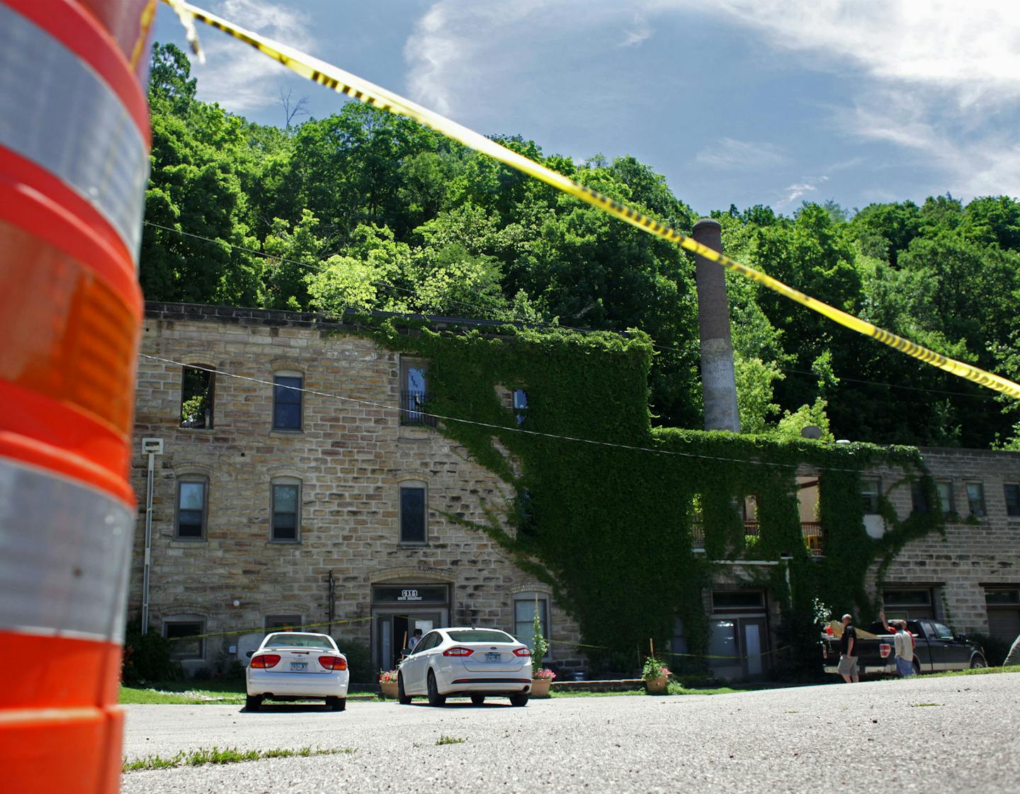 Yellow tape and orange cones block off the parking lot of the historic Jordan Brewery after a mudslide severely damaged the building two weeks ago during the June rainstorms.