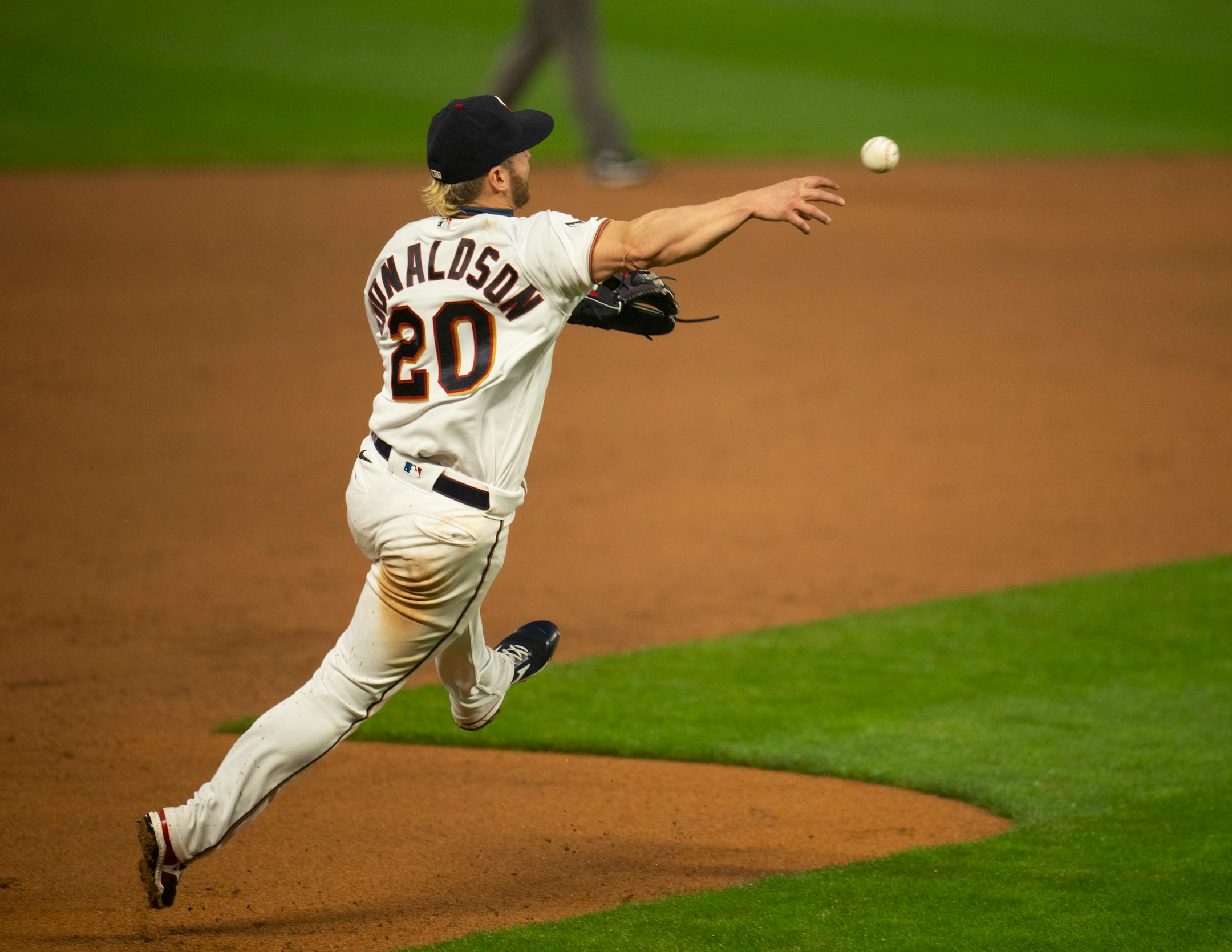 Minnesota Twins third baseman Josh Donaldson (20) threw to first too late to nab Chicago White Sox second baseman Nick Madrigal (1) in the sixth inning. He earned an error when he bobbled a ground ball hit by Madrigal.