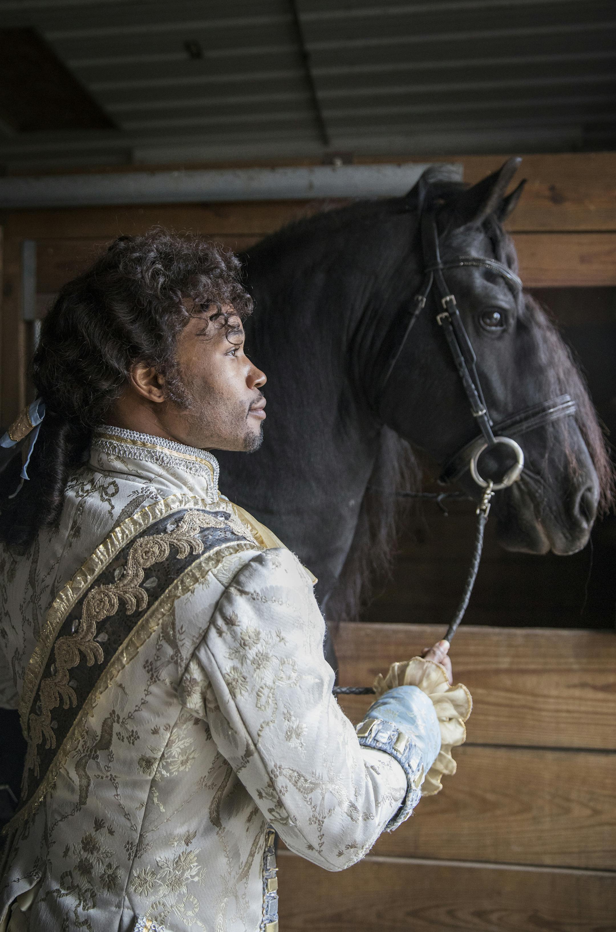 Actor David Murray poses with El Dante, a Friesian stallion, at Carisbrooke Farm in Stillwater. ] (Leila Navidi/Star Tribune) leila.navidi@startribune.com BACKGROUND INFORMATION: Actor David Murray rides El Dante, a Friesian stallion, for a Star Tribune photo shoot at Carisbrooke Farm in Stillwater on Friday, October 28, 2016. Murray plays Prince Charming in the Children's Theatre revival of "Cinderella" and is the new darling of the Twin Cities theater scene. ORG XMIT: MIN1610281514510231