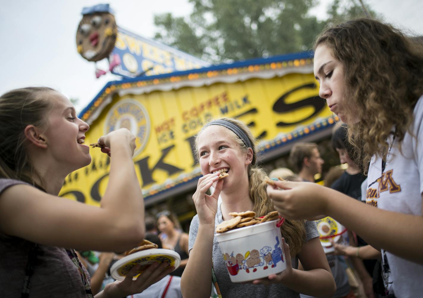 From left, Marie LaFrance, Elise Elliott and Ireland Dawood, all 14, enjoyed chocolate chip cookies just purchased from Sweet Martha's at the Minnesota State Fair.