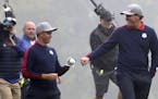 Rickie Fowler and Phil Mickelson fist pump as they come back in their match during the 2016 Ryder Cup, Friday morning Play at Hazeltine National Golf 