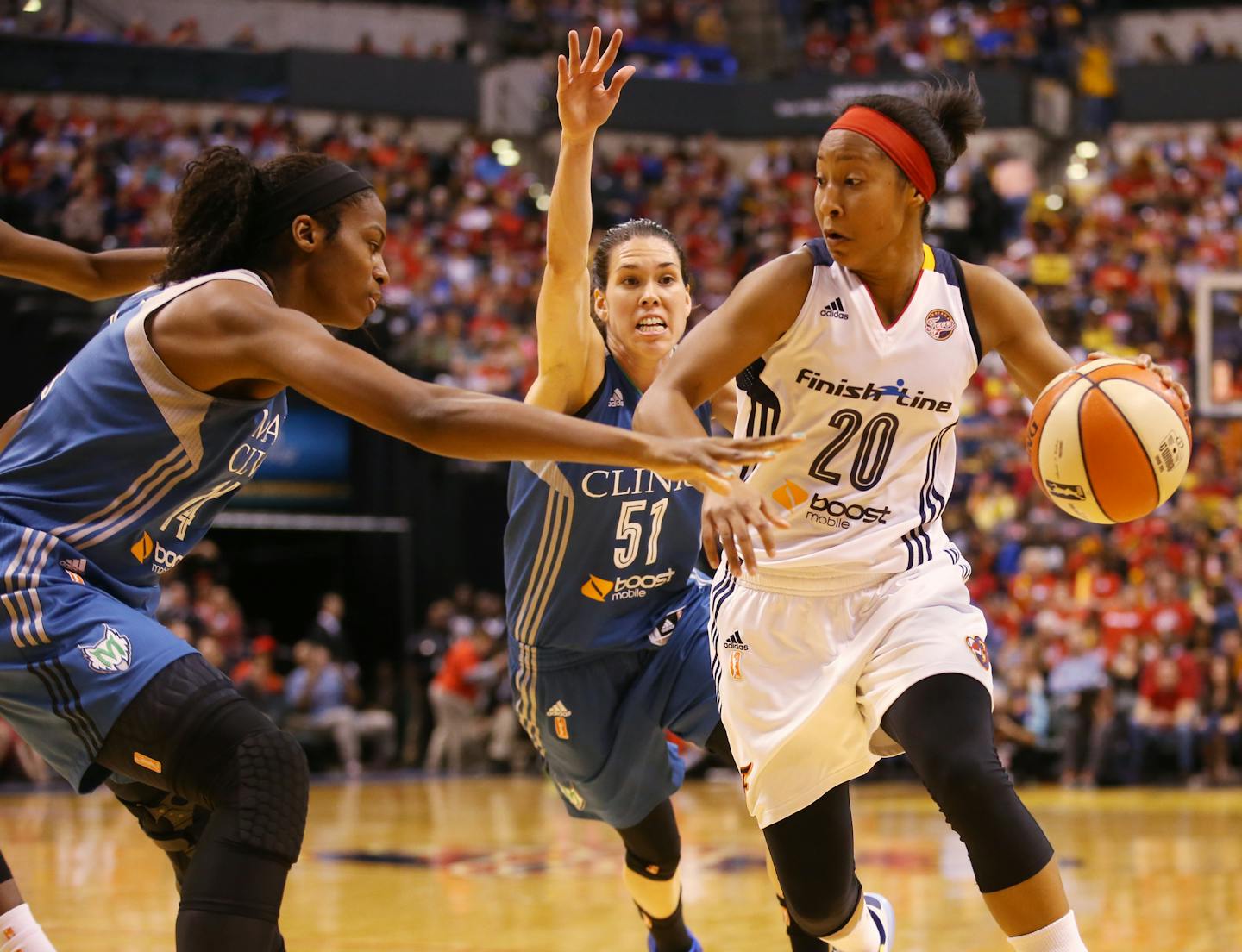 Indiana Fever guard Briann January (20) drives past Minnesota Lynx guard Anna Cruz (51) and Minnesota Lynx forward Devereaux Peters (14), left, during the third quarter. ] KYNDELL HARKNESS kyndell.harkness@startribune.com / BACKGROUND INFORMATION: During game three of the WNBA Finals at Bankers Life Field House in Indianapolis on Friday, October 9, 2015.