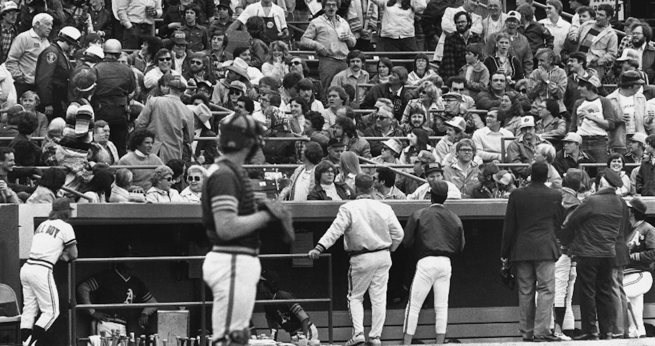 During this April 26, 1980 Twins-Oakland game at Met Stadium, play was halted in the sixth inning as Bloomington police, upper left, ejected fans who had been throwing marshmallows at A's manager Billy Martin (between umpires at lower right).