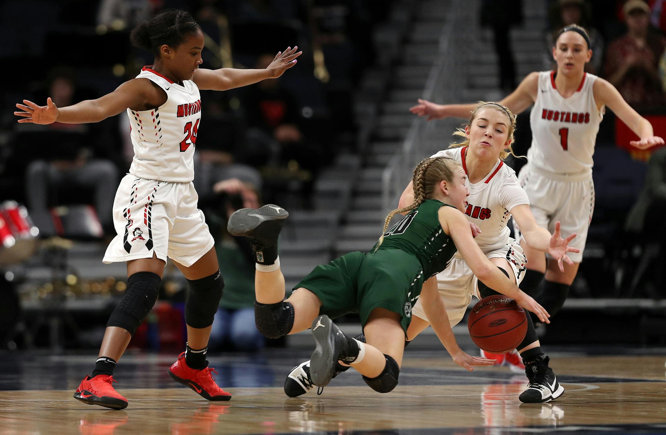 Roseau High School guard Katie Borowicz (20) got tripped up as Maranatha Christian Academy guard Desiree Ware (24) and Maranatha Christian Academy guard Kylie Post (10) defended in the first half. ] ANTHONY SOUFFLE ï anthony.souffle@startribune.com Roseau High School played Maranatha Christian Academy in a Class 2A semifinals basketball game Friday, March 16, 2018 at the Target Center in Minneapolis.