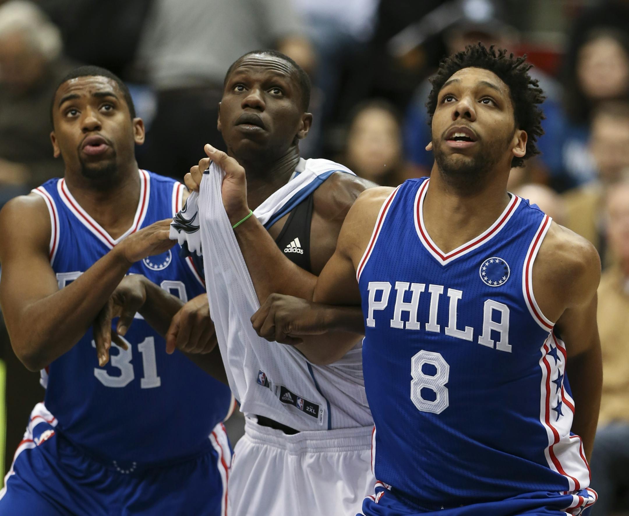 Timberwolves center Gorgui Dieng (5) was sandwiched between 76ers guard Hollis Thompson (31) and center Jahlil Okafor (8) while waiting for a free throw to drop in the second quarter Monday night.
