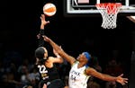 Las Vegas Aces forward A'ja Wilson (22) shoots over Minnesota Lynx center Sylvia Fowles (34) during a WNBA basketball game in Las Vegas on Thursday, M