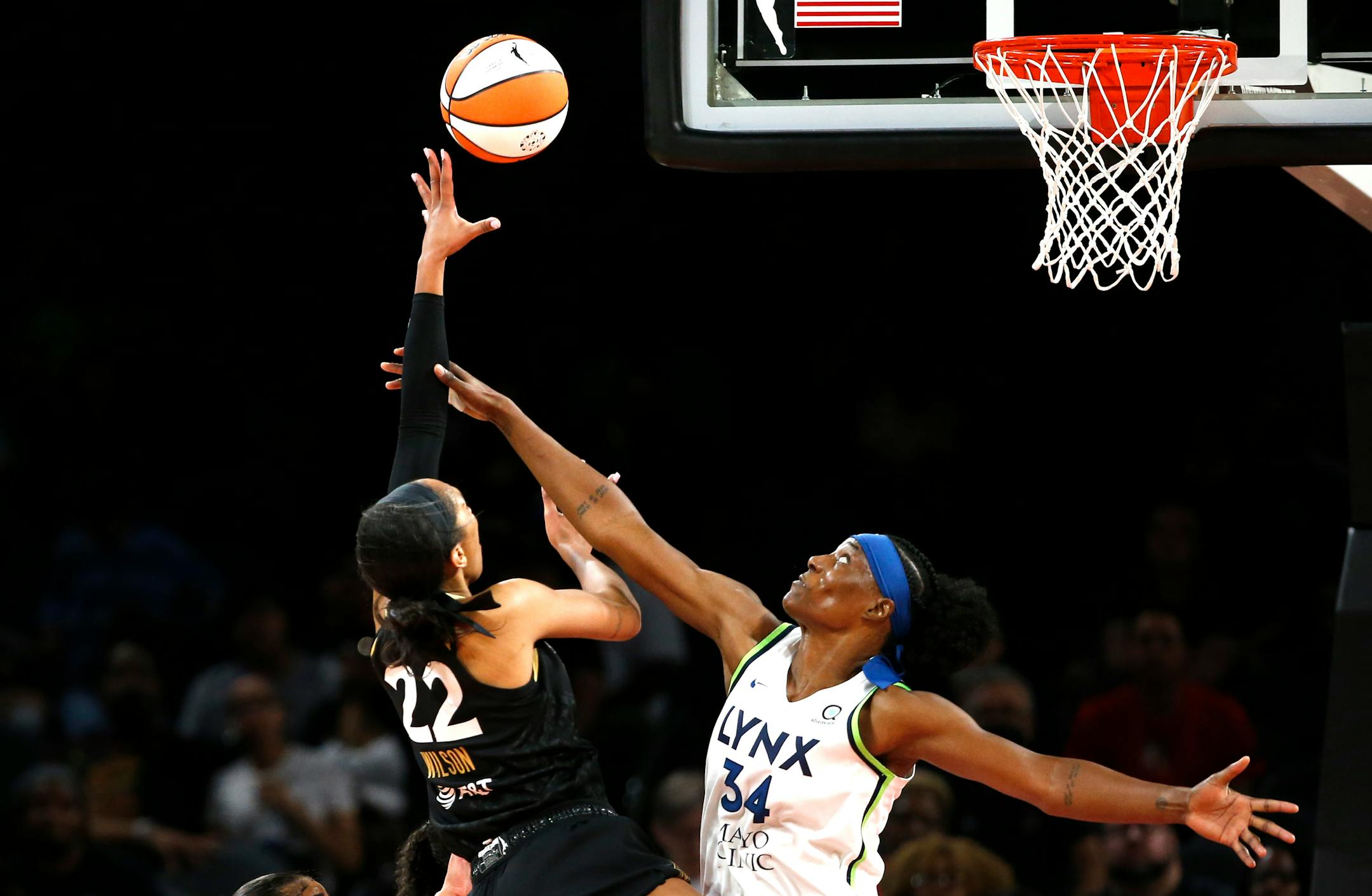 Las Vegas Aces forward A'ja Wilson (22) shoots over Minnesota Lynx center Sylvia Fowles (34) during a WNBA basketball game in Las Vegas on Thursday, May 19, 2022. (Steve Marcus/Las Vegas Sun via AP)