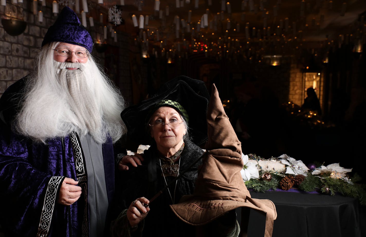 Reilona McVai as Albus Dumbledore and Gail Mason as Minerva McGonagall posed for a portrait with the sorting hat in the Great Hall.