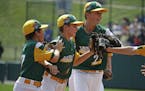 Jaxon Knutson, second from right, celebrated Friday with Carson Timm, left, and Jack Brandi, center, after making a diving catch to end the fifth inni