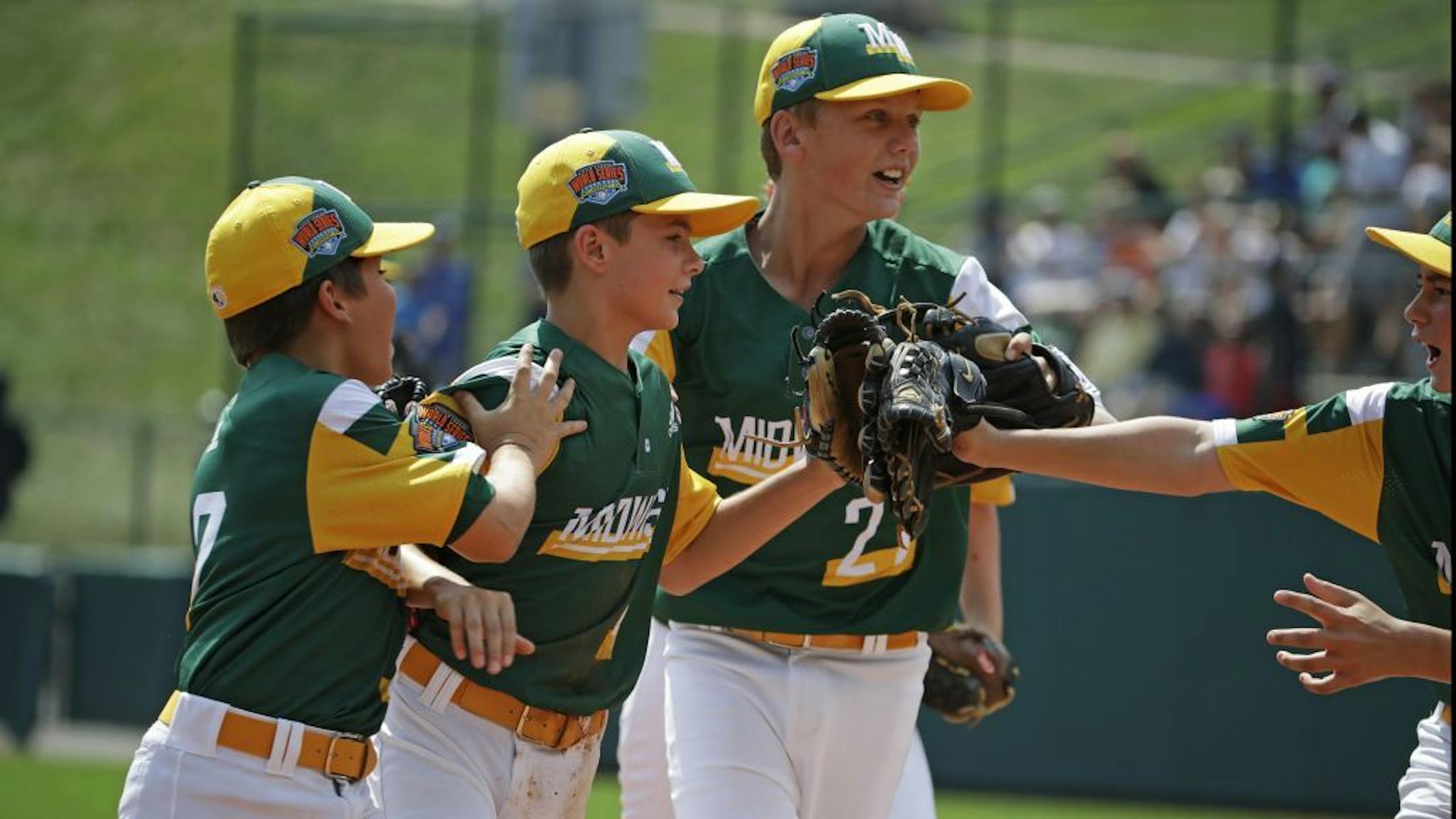 Jaxon Knutson, second from right, celebrated Friday with Carson Timm, left, and Jack Brandi, center, after making a diving catch to end the fifth inning of their opening game.