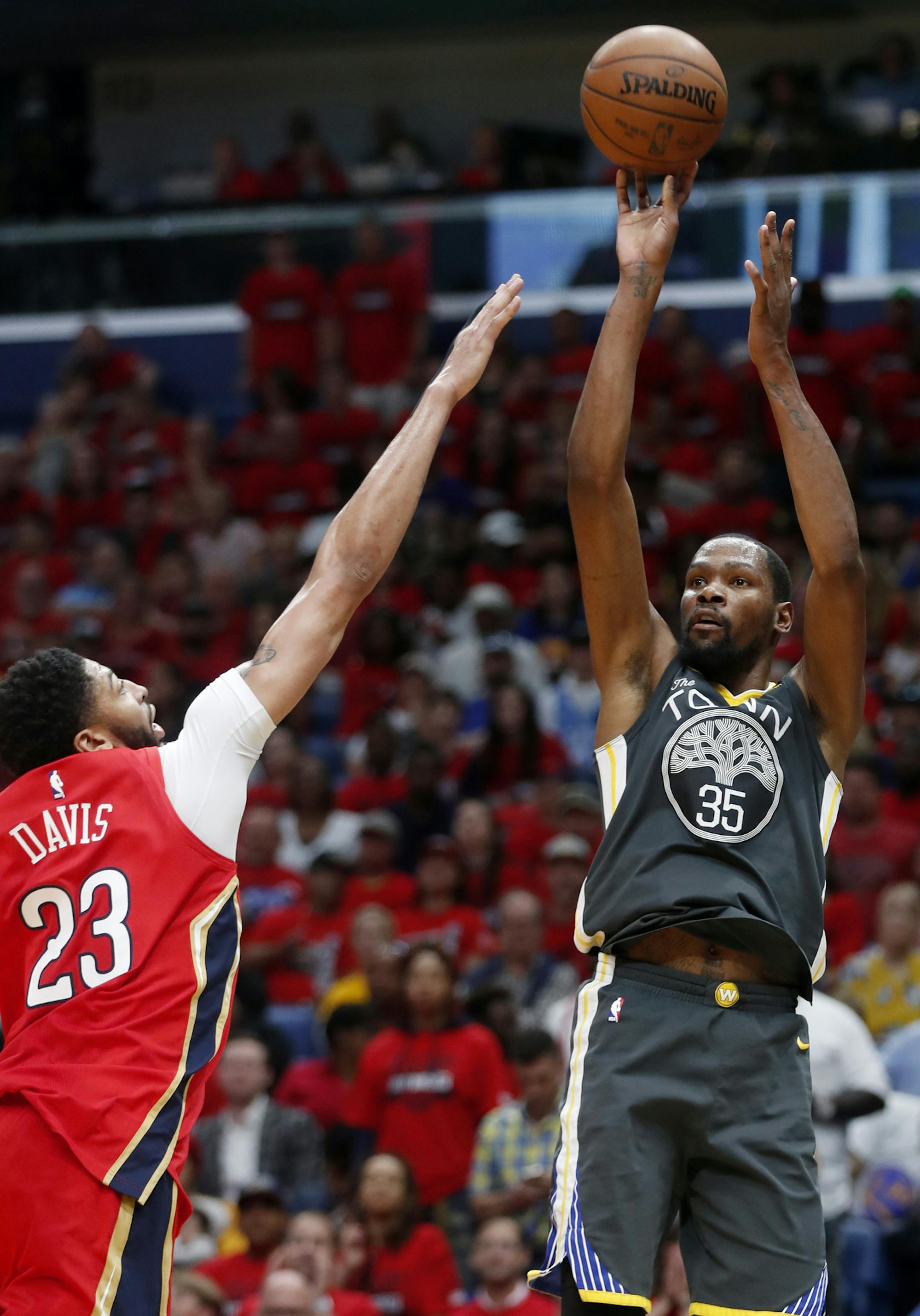 Golden State Warriors forward Kevin Durant (35) shoots against New Orleans Pelicans forward Anthony Davis (23) in the first half of Game 4 of a second-round NBA basketball playoff series in New Orleans, Sunday, May 6, 2018. (AP Photo/Gerald Herbert)