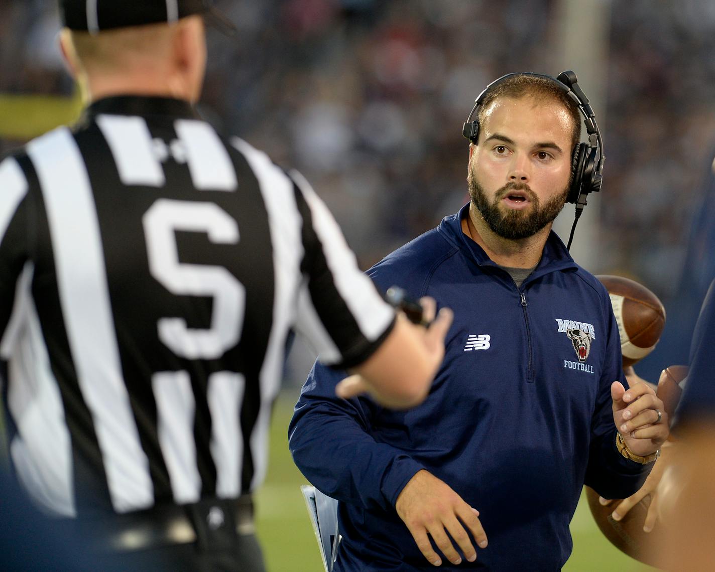 CORRECTS TO JOE HARASYMIAK NOT JACK COSGROVE - Maine head coach Joe Harasymiak, right, looks at an official during the first half of an NCAA college football game against Connecticut , Thursday, Sept. 1, 2016, in East Hartford, Conn. (AP Photo/Jessica Hill) ORG XMIT: CTJH103