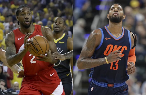 Kawhi Leonard, left, and Paul George, right, are joining forces next season with the Los Angeles Clippers.