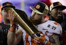 Clemson's Ben Boulware kisses the championship trophy after the NCAA college football playoff championship game against Alabama Tuesday, Jan. 10, 2017