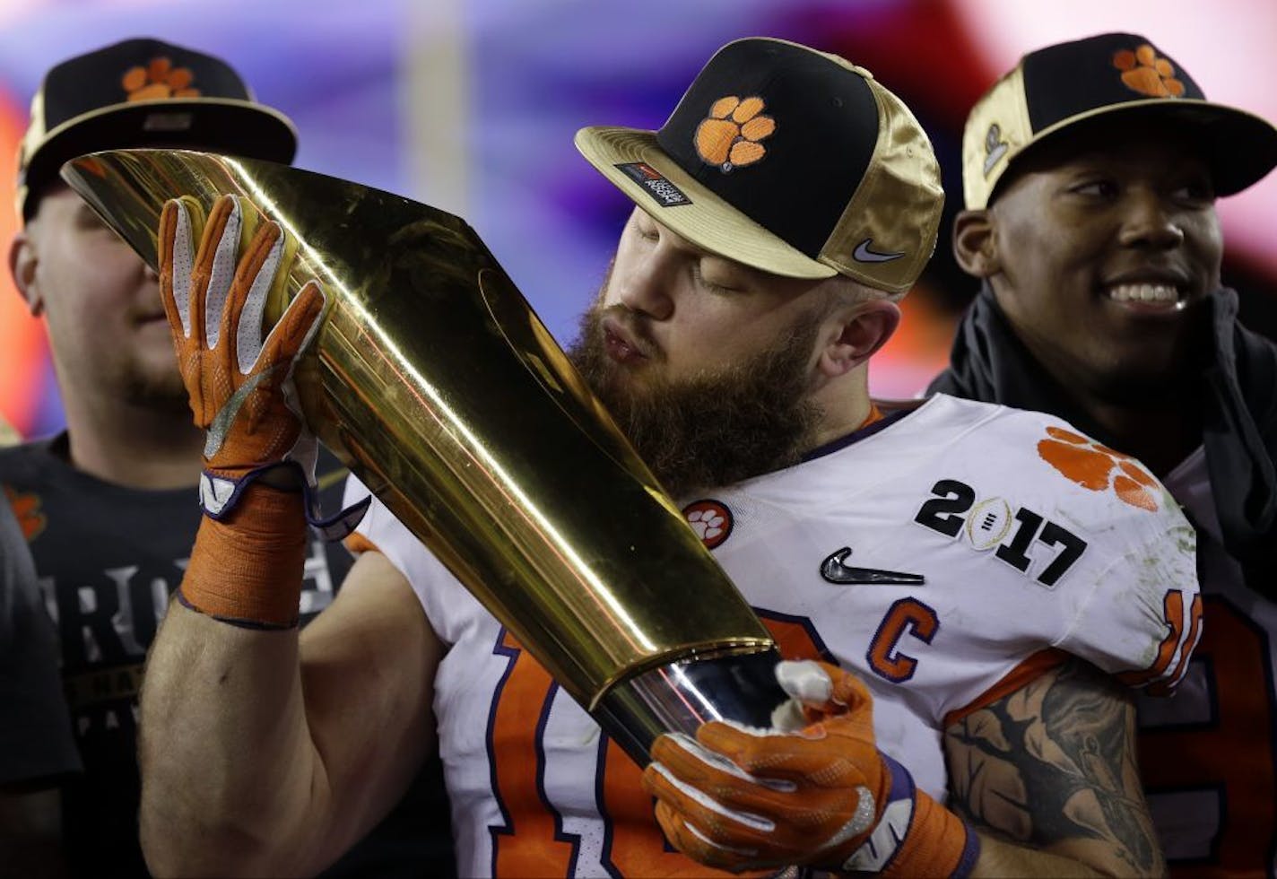 Clemson's Ben Boulware kisses the championship trophy after the NCAA college football playoff championship game against Alabama Tuesday, Jan. 10, 2017, in Tampa, Fla. Clemson won 35-31.