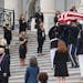 The flag-draped casket of Justice Ruth Bader Ginsburg is carried out by a joint services military honor guard after lying in state at the U.S. Capitol