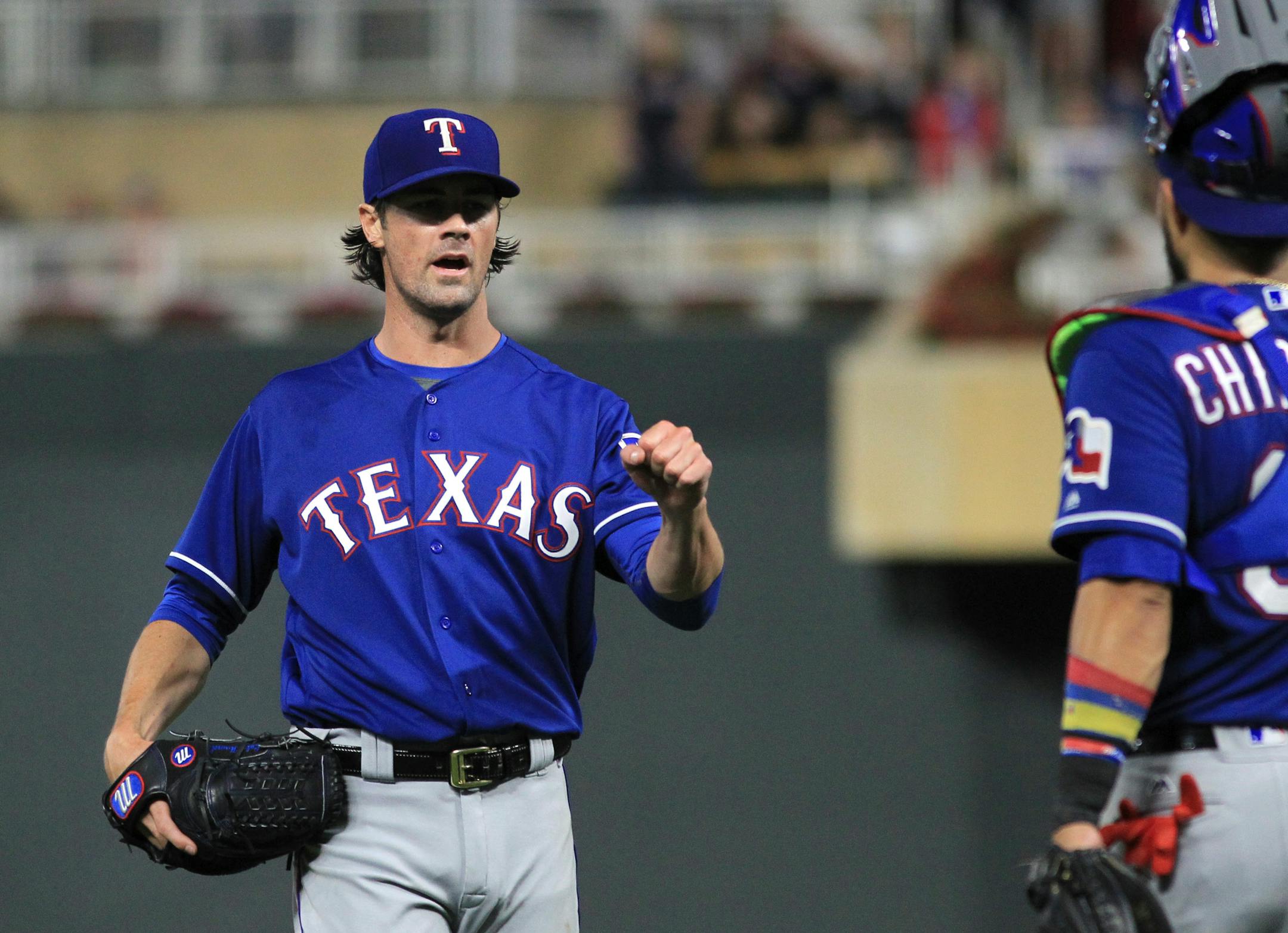 Texas Rangers pitcher Cole Hamels (35) celebrates with catcher Robinson Chirinos (61) after the Rangers defeated the Minnesota Twins during a baseball game Saturday, Aug. 5, 2017, in Minneapolis. The Rangers won 4-1. (AP Photo/Andy Clayton-King)