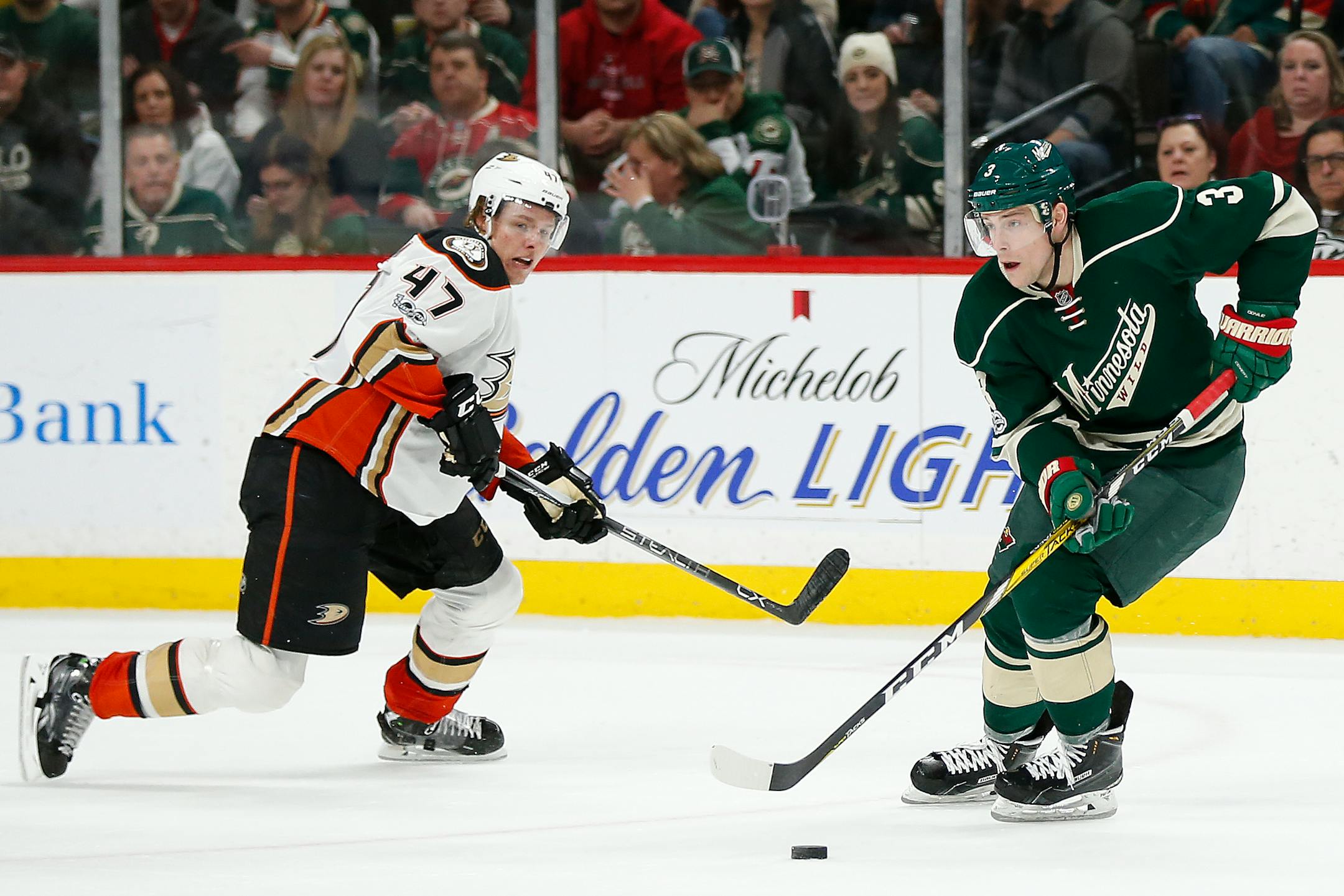 Minnesota Wild's Charlie Coyle controls the pucks against Anaheim Ducks' Hampus Lindholm in the second period of an NHL hockey game Saturday, Jan. 21, 2017, in St. Paul, Minn. (AP Photo/Stacy Bengs)
