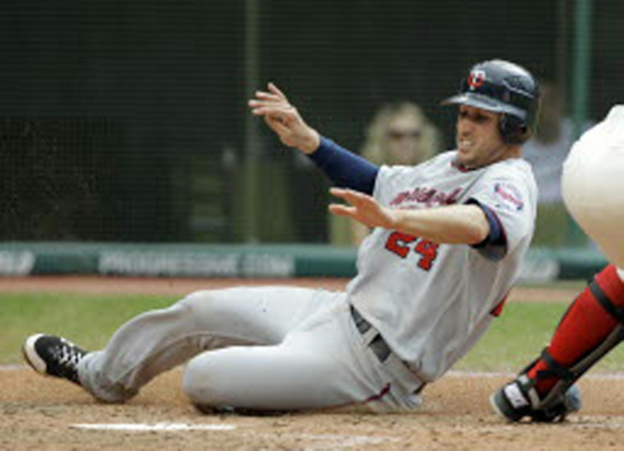 The Twins' Trevor Plouffe slid home to score on a sacrifice fly by Alexi Casilla in the eighth inning of the Twins' 6-3 victory over Cleveland on Sunday. Plouffe went 3-for-4 in the game.