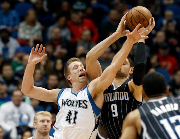 Orlando Magic�s Nikola Vucevic, right, of Montenegro, and Minnesota Timberwolves� Justin Hamilton fight for a rebound in the first quarter of an N