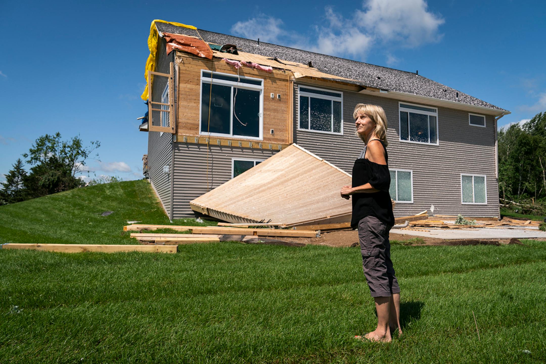 Laurie Scherf at the home she and husband Mitch moved into three months ago on Bone Lake in Scandia. The Scherfs had hoped to host their daughter Amber's wedding reception there on Saturday but can't because of the damage.