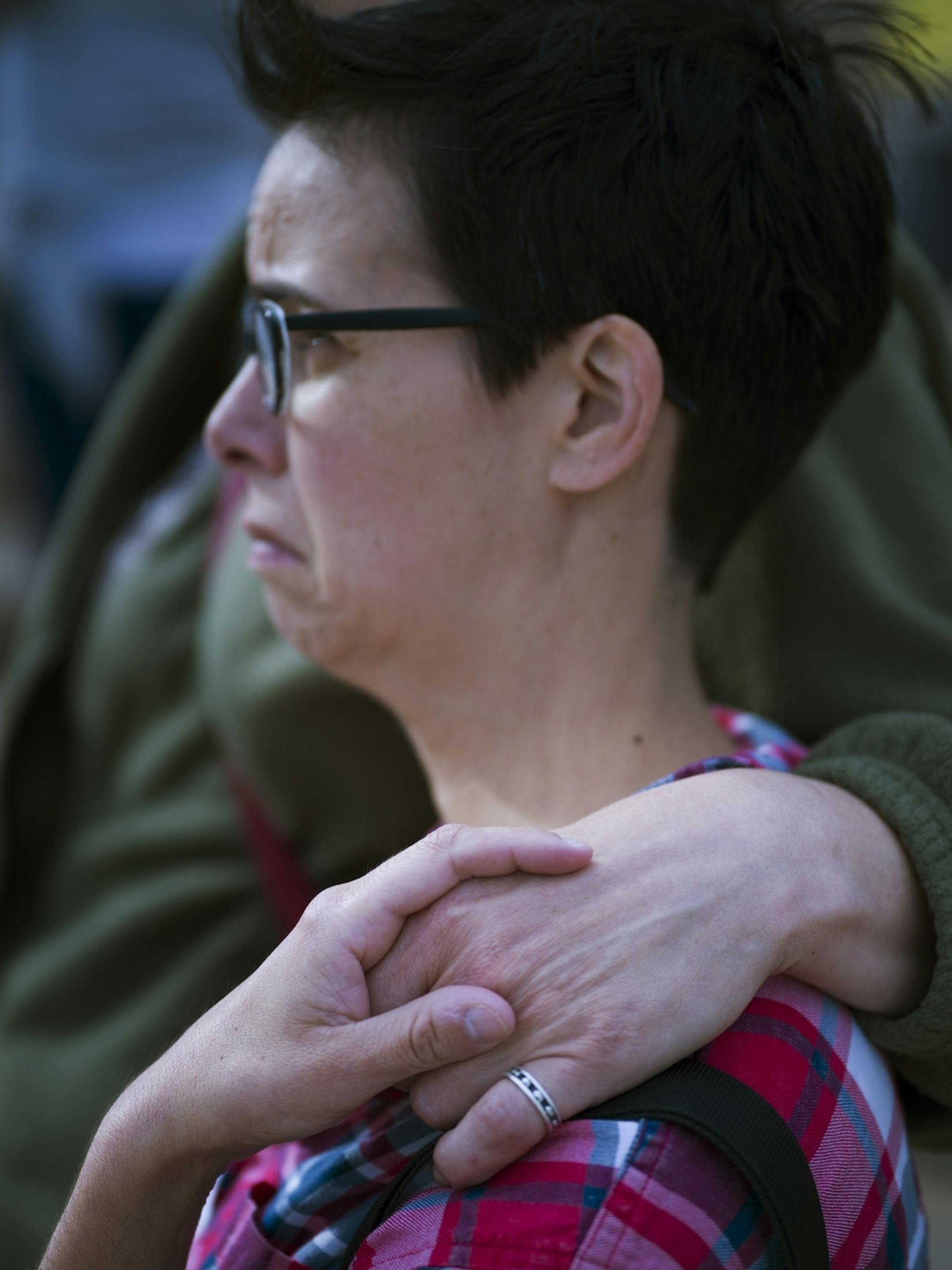 Genevieve Bennett, a sexual assault survivor was comforted by friend Laura Sterns Adam, also a survivor.