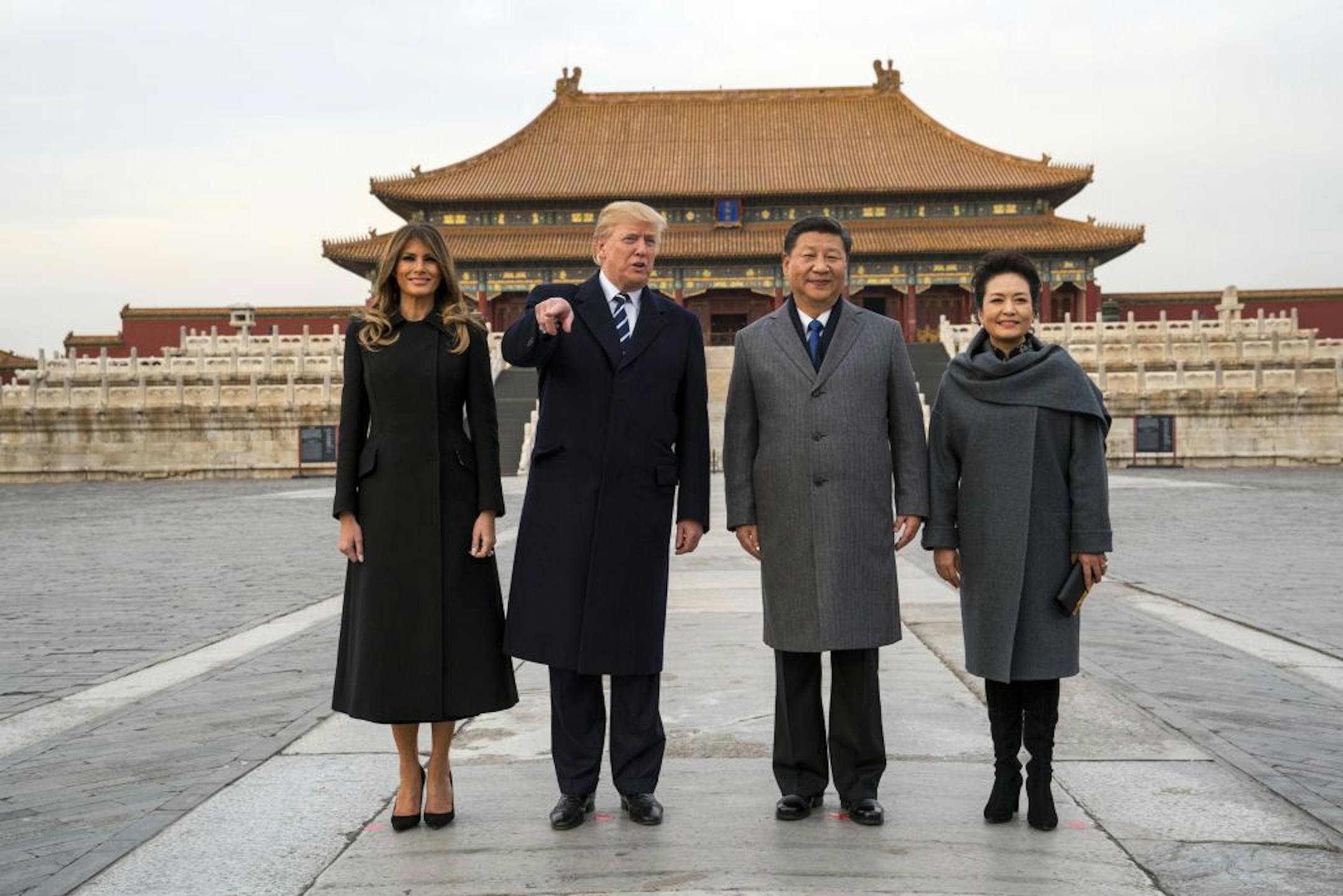 President Donald Trump gestures as he and first lady Melania Trump, left, pose for photographers with President Xi Jinping of China and his wife, Peng Liyuan, during a tour of the Forbidden City in Beijing on Nov. 8, 2017.