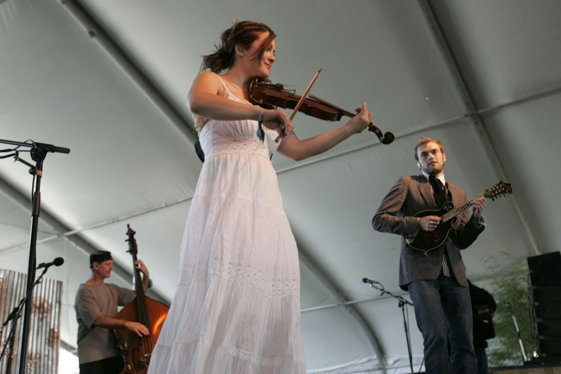 Sara Watkins, center, and Chris Thile, right, of Nickel Creek perform during Stagecoach Country Music Festival at the Empire Polo Fields in Indio, Calif., Saturday May 5, 2007.