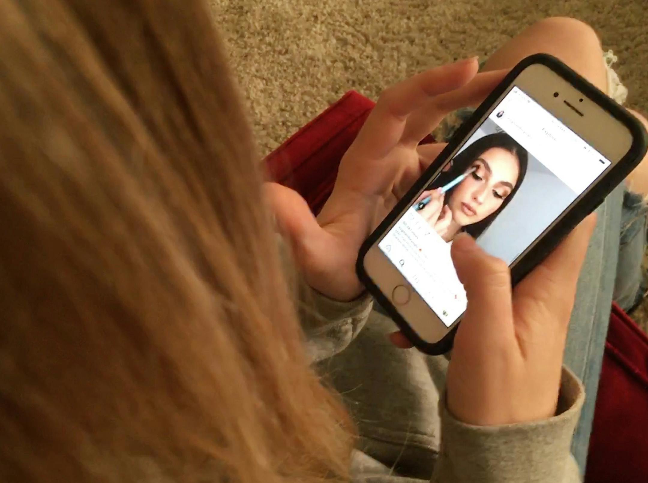 In this Nov. 1, 2018 photo, Laurel Foster looks at Instagram in San Francisco. App developers say as teens scroll through Instagram and Snapchat, tap out texts, or hole up in their rooms watching YouTube, they&#x2019;re leaving enormous digital footprints that may offer clues to their psyches. Studies are under way to find out. (AP Photo/Haven Daley) ORG XMIT: RPHD202